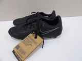 a close up of a pair of black soccer shoes on a table