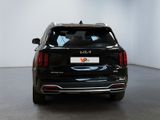 the back end of a black suv parked in a white room