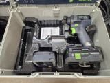 a box with a cordless drill and two batteries in it