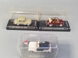 two toy cars in a clear box on a table