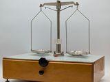 an image of a scale on a table with a bottle of wine