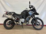 a picture of a black motorcycle parked in a garage