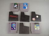 six cartouches de jeux Nintendo posées sur une table