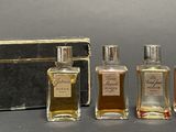 three bottles of perfume sitting next to each other on a table