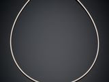 a silver necklace on a black background