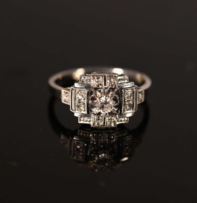 a close up of a diamond ring on a black surface