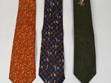 three ties are lined up in a row on a white surface