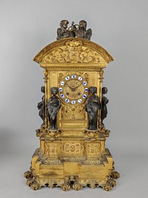 a gold clock that is sitting on a table
