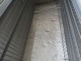 an image of a dog in a cage in the snow