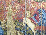 an image of a tapestry of a woman and a dog in a forest