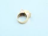 a gold ring on a blue surface with a white background
