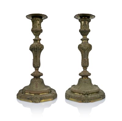 pair of antique brass candlesticks on a white background