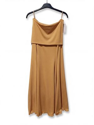the dress is hanging on a hanger on a white wall