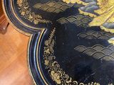 a black table with a gold design on it