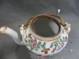 a tea pot with a handle and a handle on it