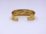 a close up of a gold ring on a white surface