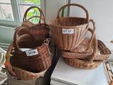 three wicker baskets are stacked on top of each other in front of a window