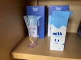 two boxes of milk on a shelf next to a blender