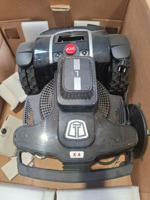 une boîte contenant une tondeuse à gazon