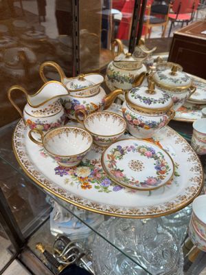 a display of china on a glass shelf in a store
