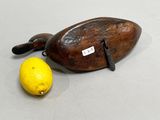 a wooden object with a lemon next to it