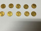 a close up of a bunch of gold coins sitting on top of a table