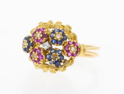 a close up of a gold ring with blue, pink and white stones