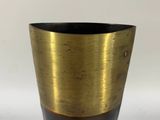 a vase that is sitting on a white surface