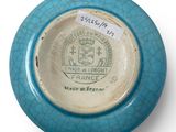 a blue and white bowl with a label on it