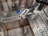 a sink with a faucet and a lot of bottles in it