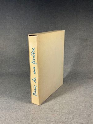 an old book with blue writing on it sitting on a table