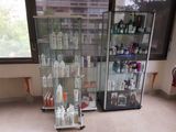 a display case with many bottles in it in a room