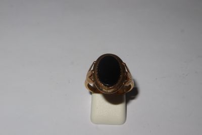 an image of a gold ring with a black stone on it