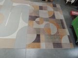 a picture of a room with a large rug on the floor