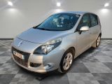 the small silver car is parked in a room with a checkered floor