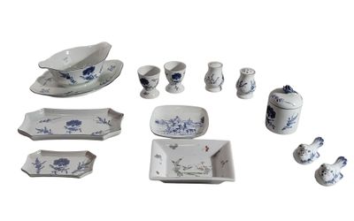 several pieces of blue and white porcelain are arranged on a white surface