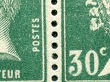 two green postage stamps with a portrait of a man and a woman