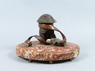 a small statue of a man sitting on a rock