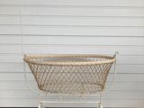 a white basket that is sitting on the ground