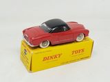 a red toy car sitting on top of a yellow box