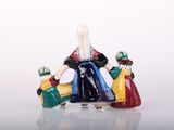 a figurine of a woman and two children on a scooter