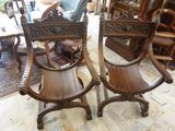 two wooden chairs that are sitting in a room