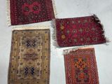 four oriental rugs are laid out on the floor