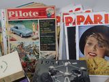 a pile of magazines and a clock on a table