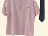a pink shirt and a black tie hanging on a hanger