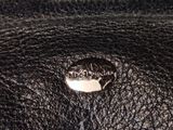 the inside of a black leather purse with a silver metal clasp