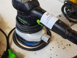 a sander that is sitting on a table with other tools