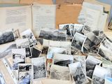 a lot of old photographs on the table