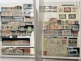 many different stamps on display in a glass case