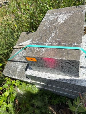 a cement block with a green ribbon on it